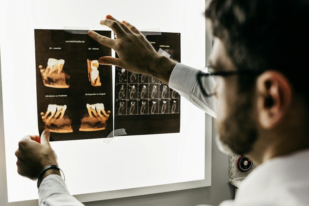 Dental professional discussing oral surgery and dental X-rays with a patient