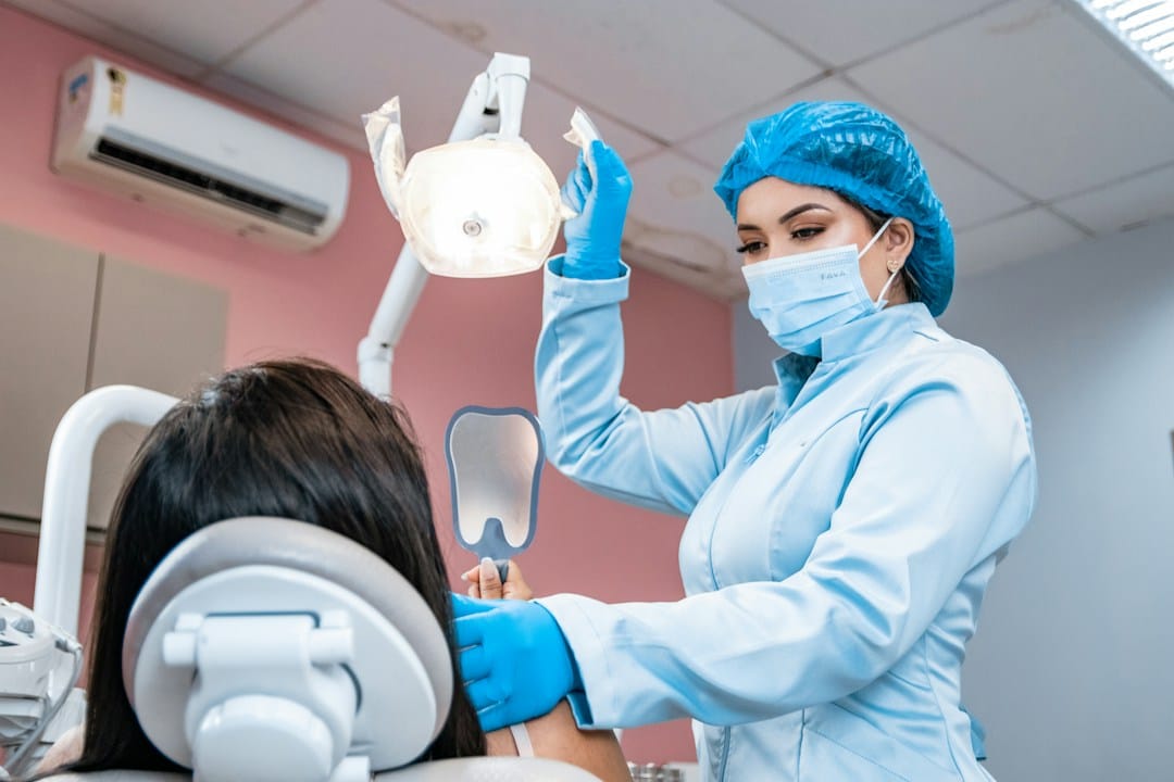 Dentist examining a patient's teeth during a checkup for possible wisdom teeth symptoms