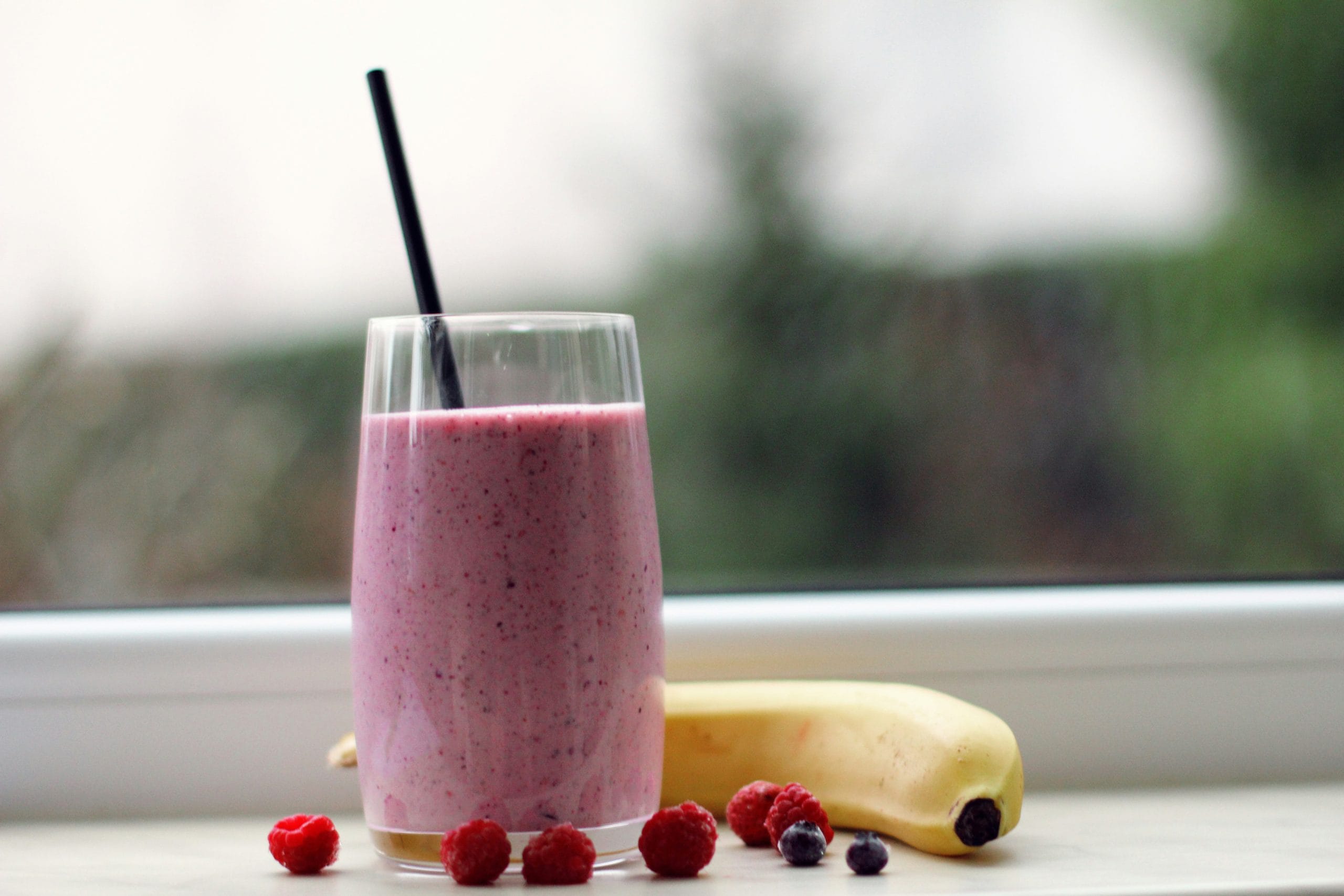 Pink smoothie as a soft drink option after wisdom teeth removal; sip from a cup, not a straw