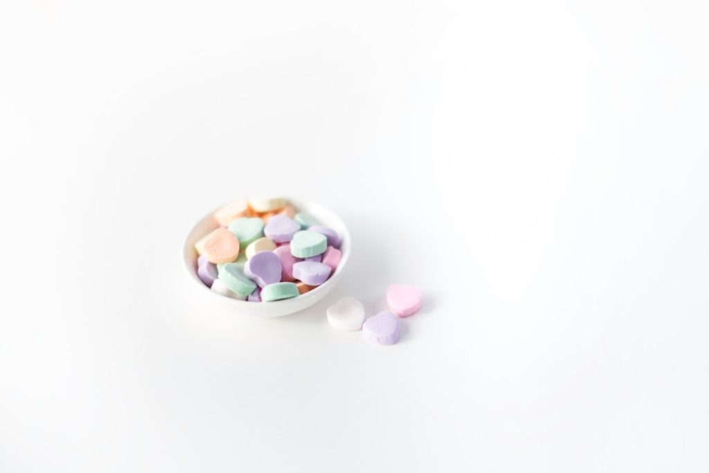 Colorful candy pieces on a plate illustrating why patients should check fasting instructions before wisdom teeth surgery