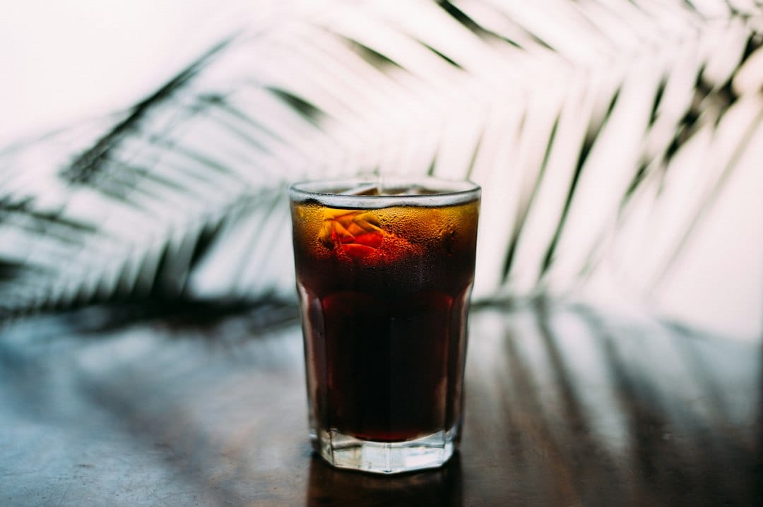 Cold beverage in a clear glass used to illustrate drink choices during wisdom teeth recovery