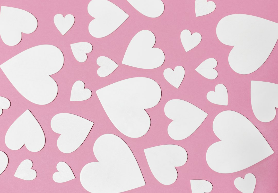 Soft pink background decorated with white hearts