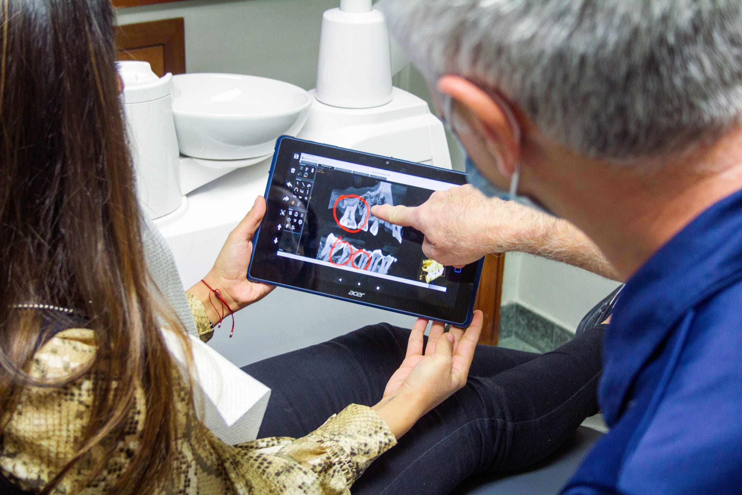 Dental professional discussing wisdom teeth treatment with a patient
