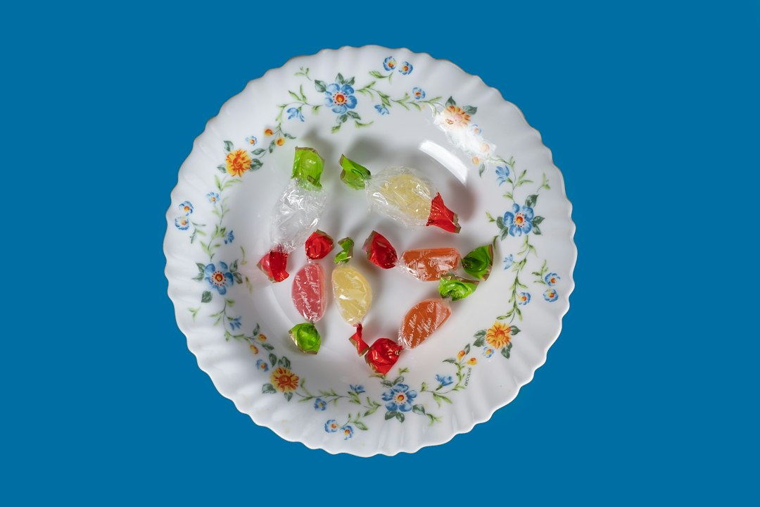 Gummy candies on a white plate illustrating sweets that count as food before anesthesia