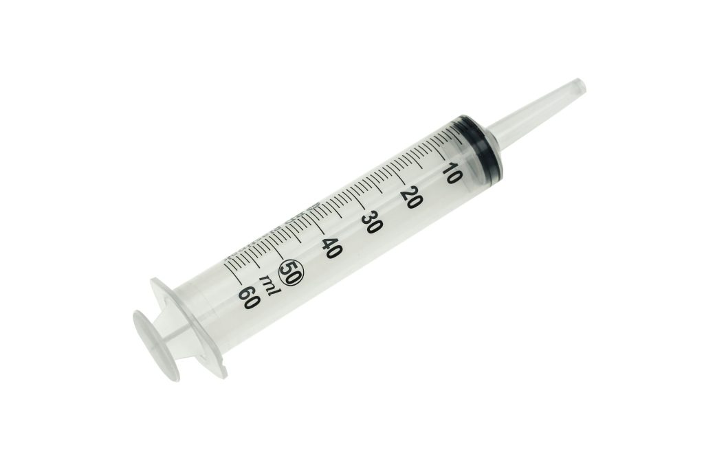 Irrigation syringe used to gently rinse a healing wisdom tooth socket, when advised by a dentist