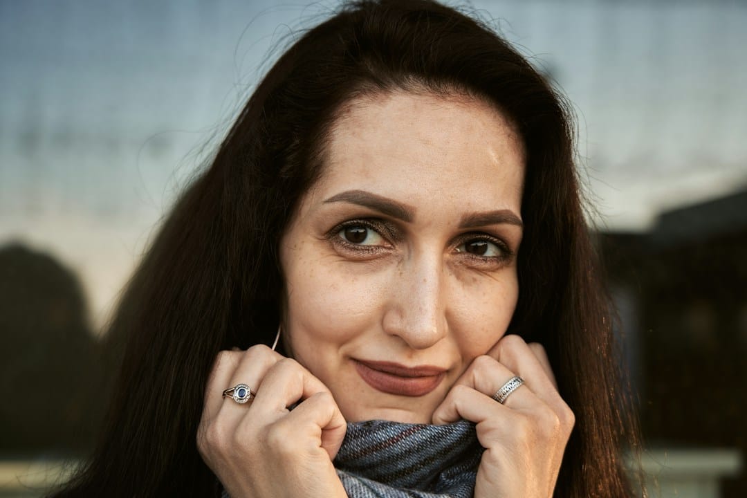 Woman gently holding her jaw while recovering from dental discomfort