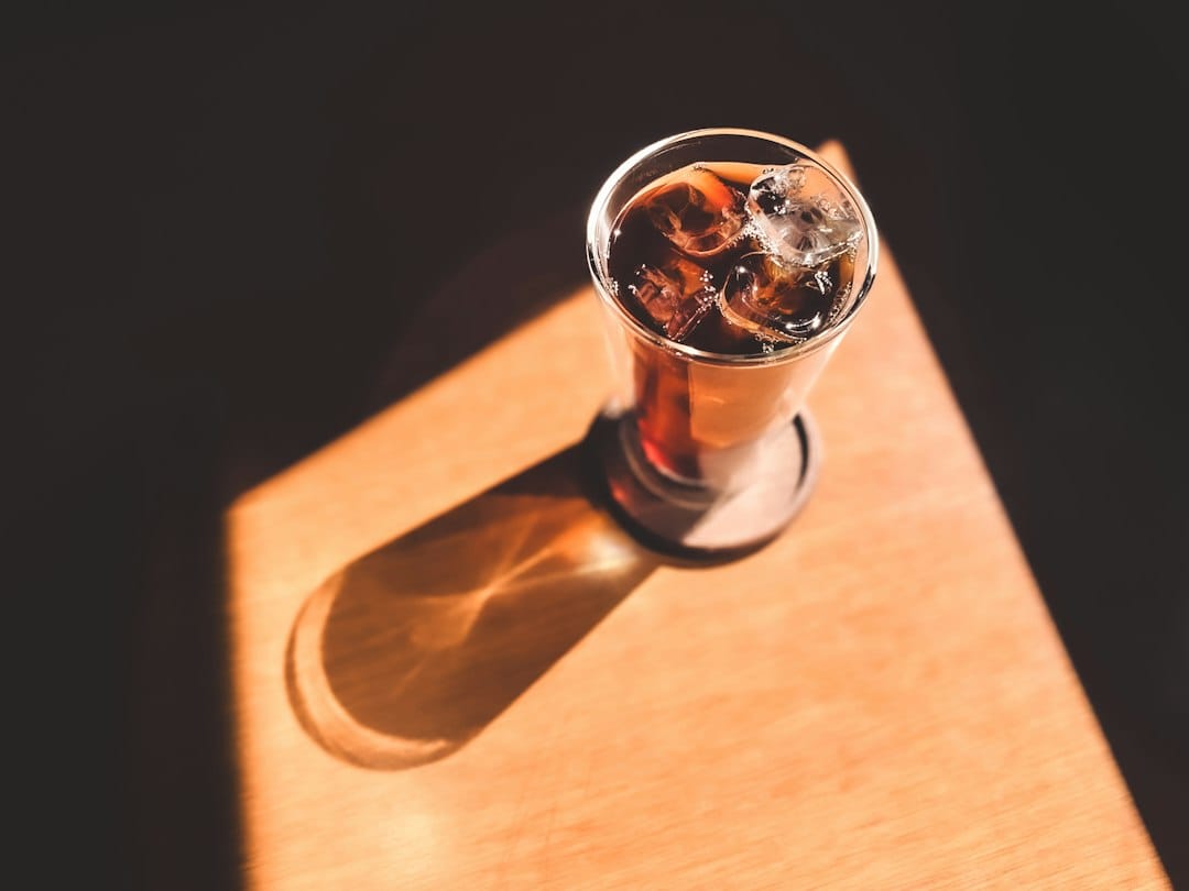 Glass of soda illustrating why carbonated drinks are best avoided early after wisdom teeth removal