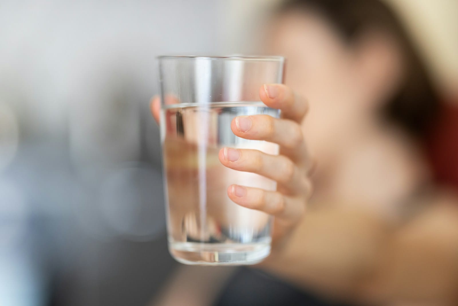 Glass of water used for gentle hydration and oral care during wisdom teeth recovery